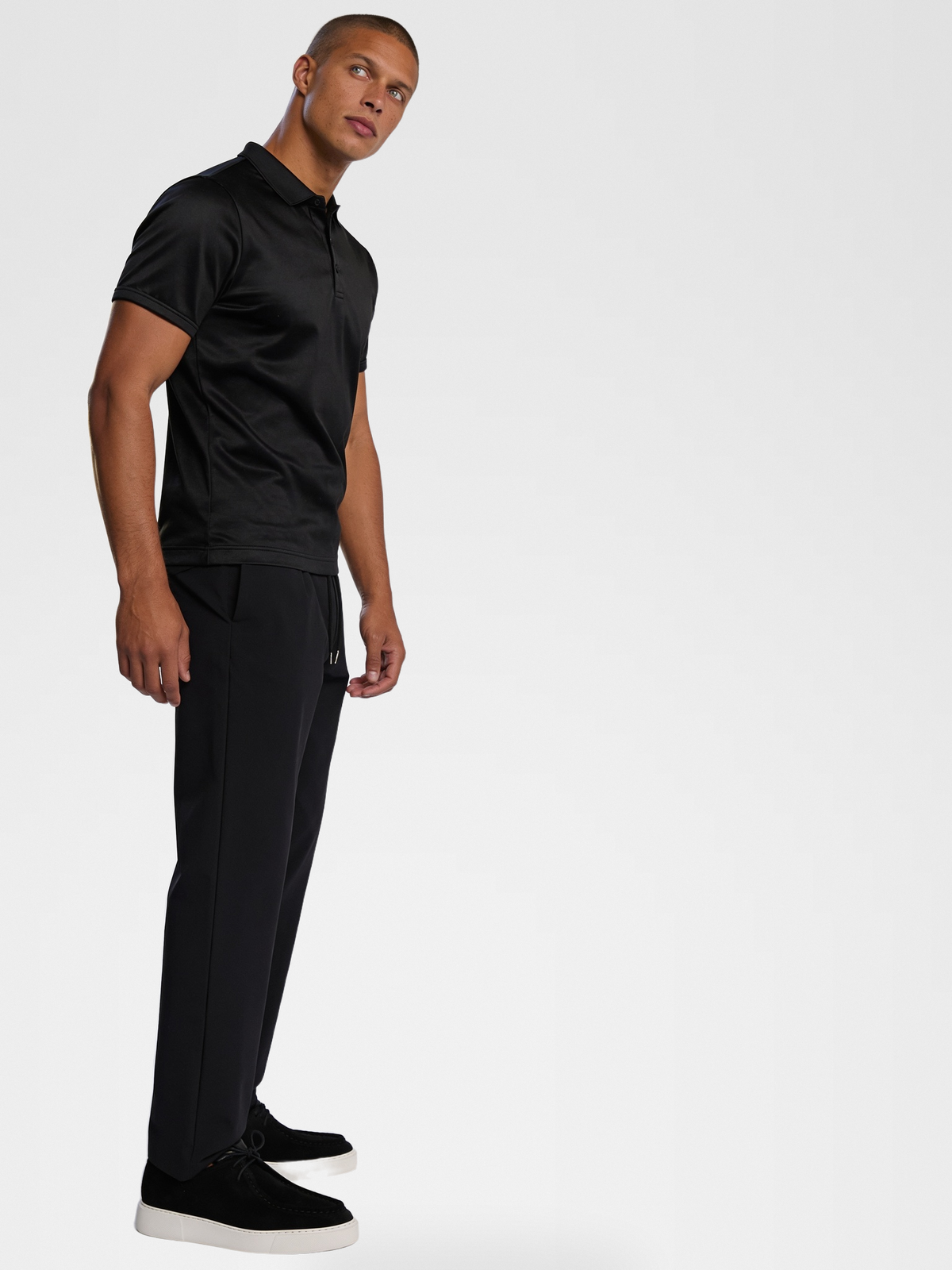 black imperial polo, black urbanpants, black shoe — lightskin_model — 3/4 Side